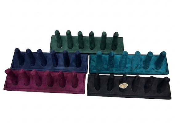 velvet 6-slot ring display stand for jewelry store display with decorative pearl ring showcased on soft velvet holder.